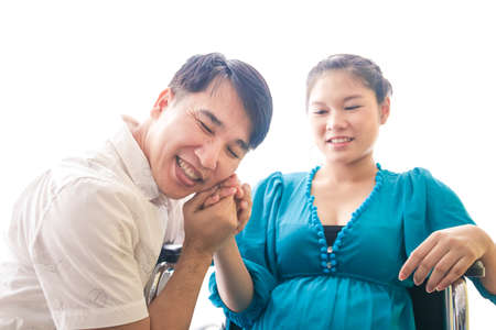 Husband shaking hands pregnant wife He is happy to have children. Family building concept Pregnancy...
