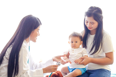 The mother took a little son to see the doctor regularly according to the appointment. To check the baby's health periodically. Child Health Check Program Conceptの写真素材