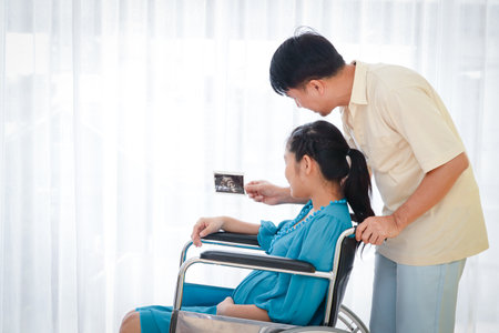 The husband takes care of both pregnant wives. View x-ray images Welcome the baby that is about to come out.の写真素材