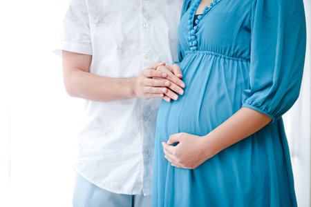 The husband takes care of his pregnant wife. Help her feel more comfortable with her changing body. The concept of creating a family, childbirthの写真素材