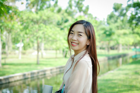 Office girl holding a white paper box, put files and music headphones Happy smileの写真素材