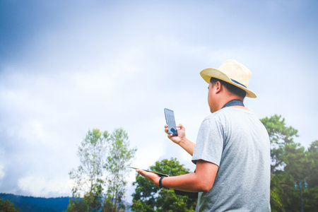 Asian young men doing agricultural farm business Hold the phone to talk