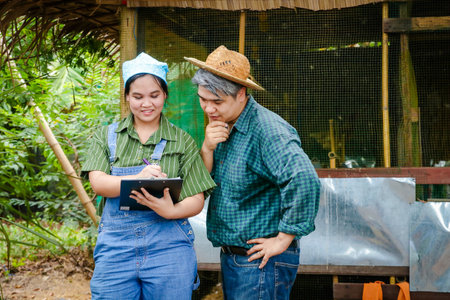 Asian women and men Doing organic farming, recording dataの写真素材