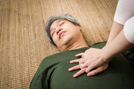 Fat elderly man Emergency sickness stopped breathing, wife performed first aid CPR to save life Resuscitation by heart pumpingの写真素材