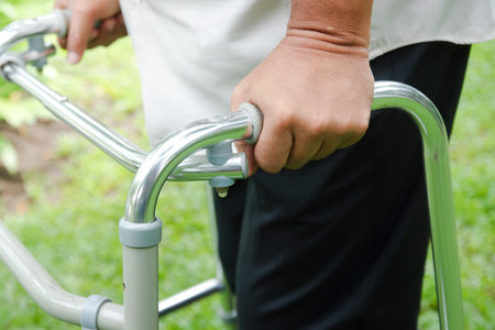 Elderly people catch walkers Help walk due to an inflamed knee. Concept of health careの写真素材