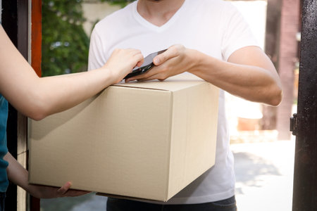 Employees deliver products to customers home. Business concept during the coronavirus, social distanceの写真素材