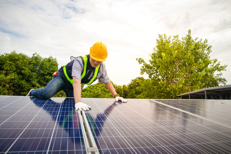 Asian technicians install panels Solar cells to produce and distribute electricity. Energy technology concept. copy spaceの写真素材