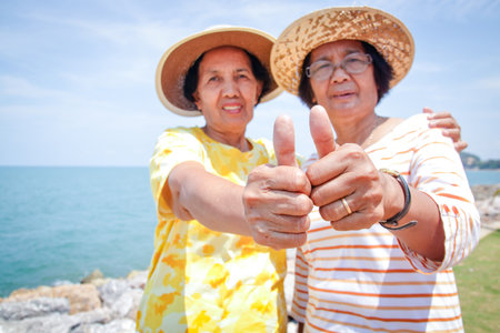 Two elderly women are friends visiting the sea in happy retirement.の写真素材