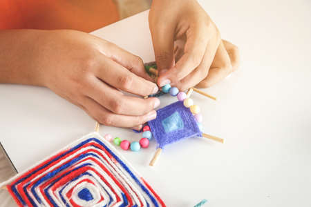 The hands of children are inventing toys, decorating the house.の写真素材