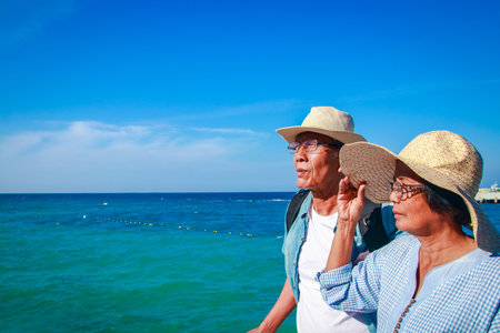 Asian elderly couple Travel after retirement Went to the sea very happy