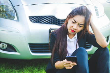 Women sitting stressed driving the wrong route Looking at mobile phones without signals Can't find the right wayの写真素材