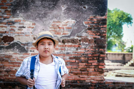 Asian boy visiting ancient ruins of ancient Ayutthaya, Thailandの写真素材