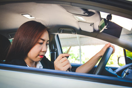 Asian women carrying car keys to travel to workの写真素材