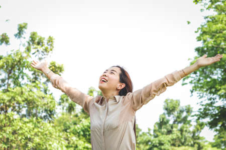 A beautiful Asian woman is an office worker. She spread both arms happy.の写真素材