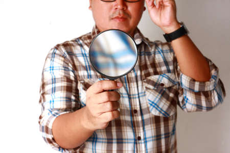 Man holding a magnifying glassの写真素材