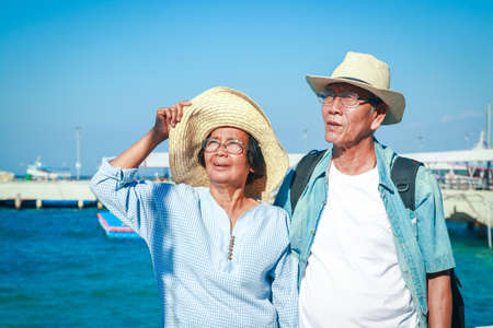 Asian elderly couple Travel after retirement Went to the sea very happyの写真素材
