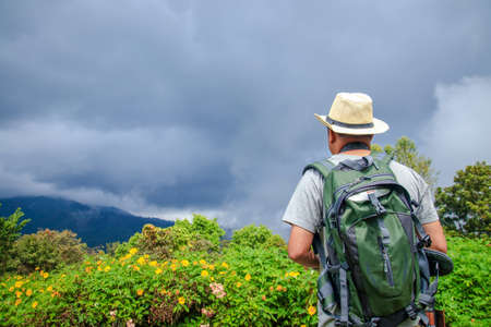 Men travel to visit the high mountains during variable weather. Travel conceptの写真素材