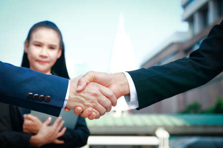 Asian businessmen stand hand in hand. The concept of business peopleの写真素材