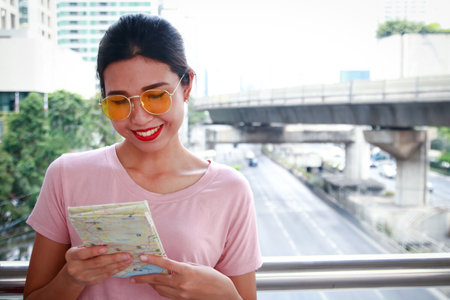 beautiful Asian girls see a map for traveling.の写真素材