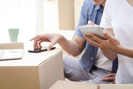 Asian couple doing business online Send the product via post. Working at home Sell ââthings through video conferencing using laptops and smartphones. Entrepreneurs doing small SME businesses.の写真素材