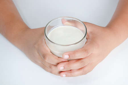 Fat boy holding a full glass of milk. Children are drinking milk. The concept of healthy eating It is beneficial for the growth of children.の写真素材