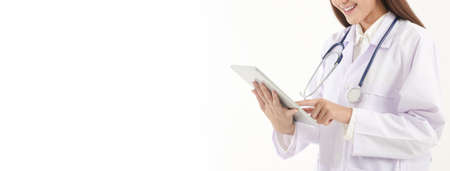 Online doctor concept Monitor patient health through a tablet connected to communication via online technology. The doctor can examine the patient via video call. White background. Copy spaceの写真素材