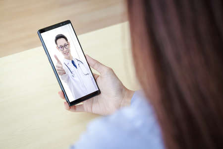 Black smartphone concept Connect to communication via online technology. The doctor can examine the patient via video call.の写真素材