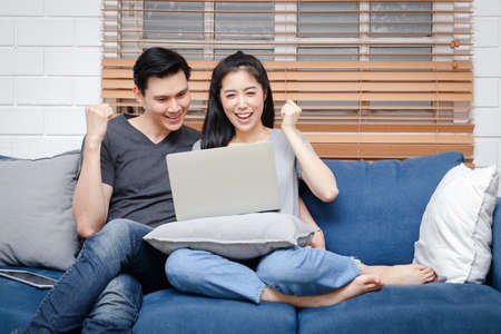 Asian couple working at home Take social distancing during the spreadの写真素材