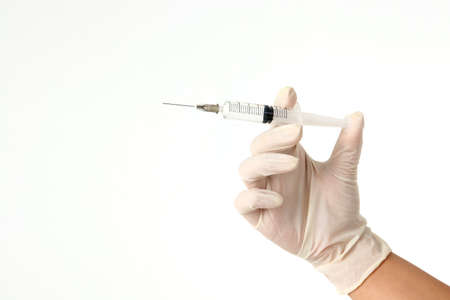 doctor wearing gloves Hold the vaccination needle. concept of medical services in hospitals Prevent viruses and germs Treatment and health care of patients. white backgroundの写真素材