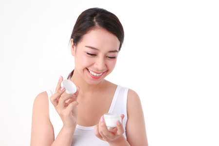 beautiful asian woman Have a beautiful smile, clean white teeth. Take care of the health of your face with skin creams. Beauty concept. white backgroundの写真素材
