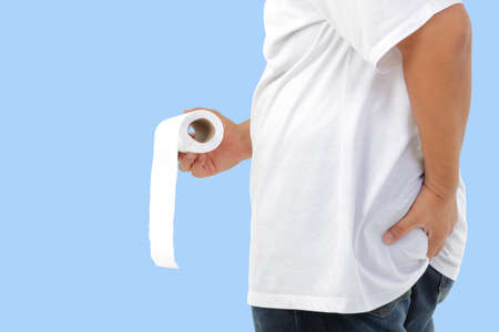 fat man wearing white shirt He had a stomachache, carrying toilet paper to go to the toilet. blue background. Clipping Pathの写真素材