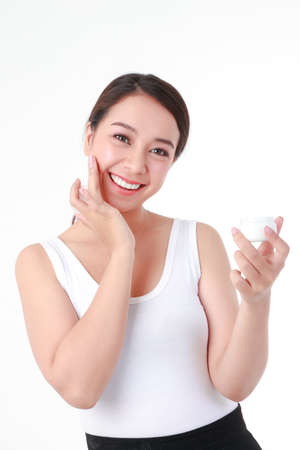 beautiful asian woman Have a beautiful smile, clean white teeth. Take care of the health of your face with skin creams. Beauty concept. white backgroundの写真素材