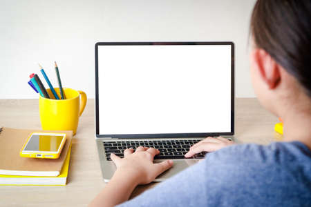 Asian schoolgirl Learn online from home through video calls. Using a laptop computer to communicate with teachers. Concept of online education. Social distancing to reduce the spread of coronavirus.の写真素材