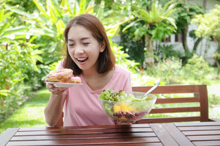Asian woman in her 40s have a bright smile Young face, healthy body Happy to eat. health care concept, eat healthy foodの写真素材