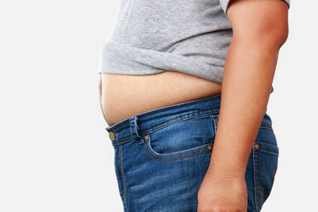 fat man wearing gray shirt with a lot of weight Take off the shirt to show the big belly. have health problems There is a risk of various diseases. weight loss concept. Clipping Pathの写真素材