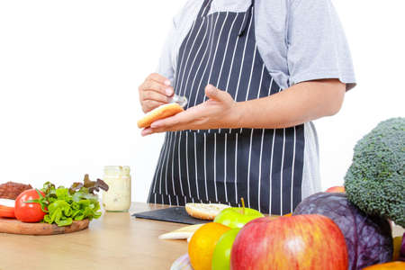 fat man cooking Hold bread and butter to make hamburgers. The concept of cooking to lose weight, eat healthy food. white backgroundの写真素材