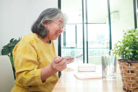 Asian old woman stay home During the epidemic She is happy to eat.の写真素材