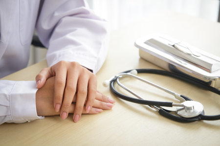doctor sitting at desk A stethoscope and examination equipment are placed on the side. concept of medical services in hospitalsの写真素材