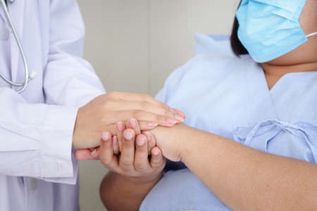 Doctors shaking hands with obese female patients Build confidence in patients to treat their illnesses. Concept of medical services in hospitals. health insuranceの写真素材