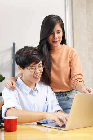 Asian lesbian couple working at home together Run a business selling online. LGBT concept. Entrepreneurship. Doing Business During the Coronavirus Pandemicの写真素材