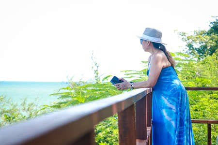 50 year old Asian woman happy touring the sea during the holidays. Concept of natural tourism in Thailandの写真素材