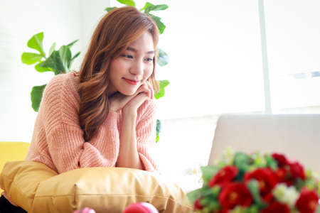 beautiful asian woman smiling happy live at home Online video call chatting with friends via laptop computer. Modern communication technology concept, social distanceの写真素材