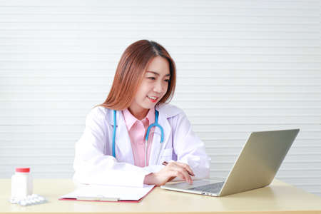 Asian beautiful woman doctor Sit and work in the office. hospital medical service conceptの写真素材