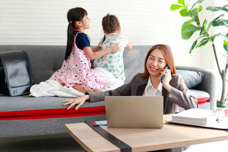Single mothers work from home during the pandemic. Mother worked while raising a small child. Family concept, raising children in modern urban societyの写真素材