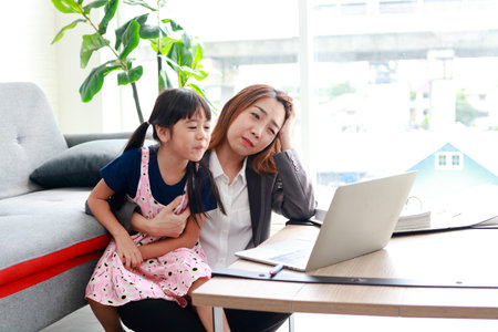 Single mothers work from home during the pandemic. Mother worked while raising a small child. Family concept, raising children in modern urban societyの写真素材