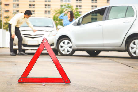 The concept of car insurance. car accident on road An emergency reflective triangular sign is placed at the front to help reduce road accidents.の写真素材