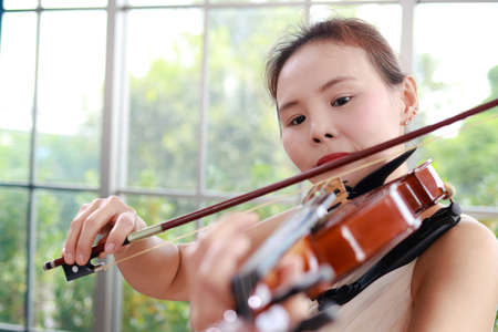 Concept of learning classical music. Close-up of a woman playing a violin Classical instruments. teacher teaching students in art schoolの写真素材