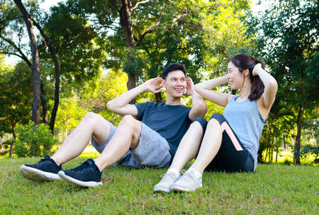 Asian couple exercising together in the park in the morning They are strong and healthy. outdoor exercise concept, healthcareの写真素材
