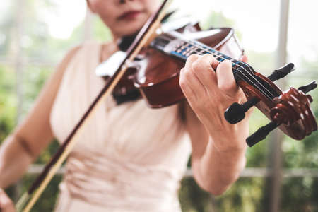 Concept of learning classical music. Close-up of a woman playing a violin Classical instruments. teacher teaching students in art schoolの写真素材