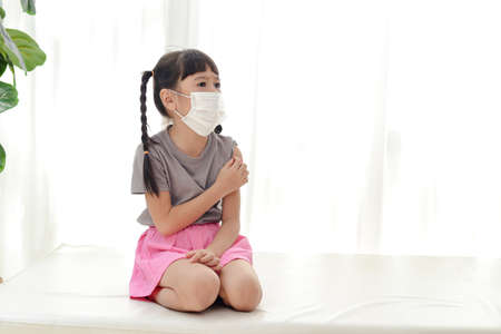 cute little asian girl wear a white maskの写真素材